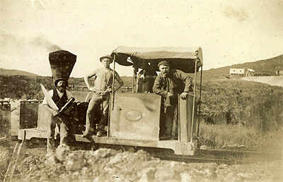 The Silverton locomotive, date not known. Note the carpenter with saw and wood plane. The mullock tip at right background may be from the Gladstone shaft